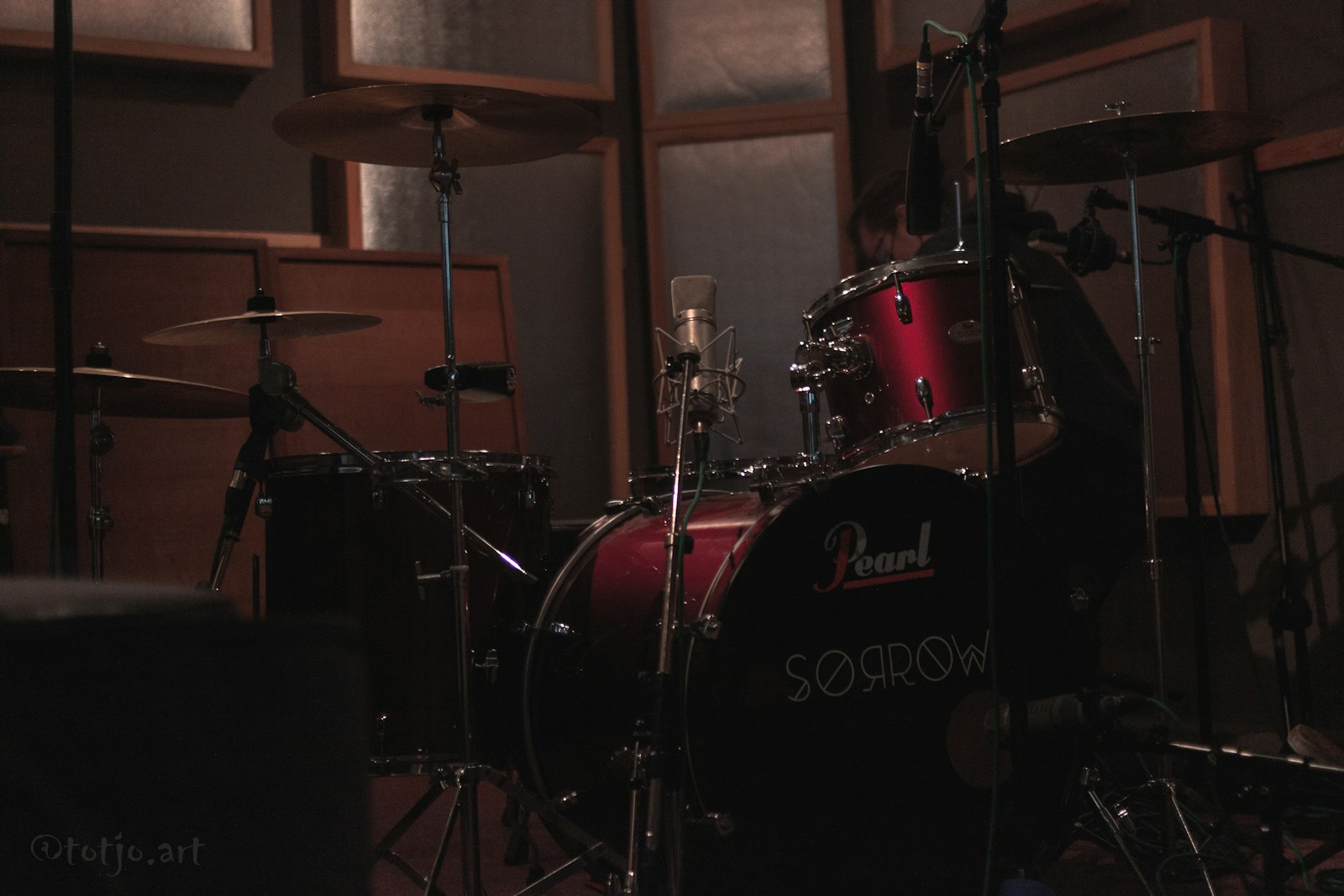 a drum set in a recording studio with sound equipment